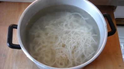 Boil the noodles. I pour boiled water on the noodles and keep it covered while stirring now and then. When it's cooked strain the noodles and keep it aside.